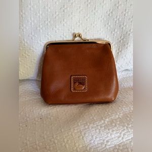Dooney and Bouke camel color wallet with kiss clasp.